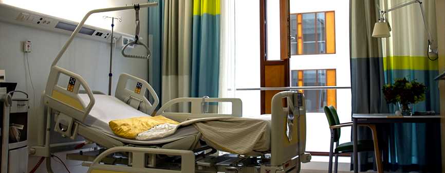 Photo of a bed in a private hospital room.