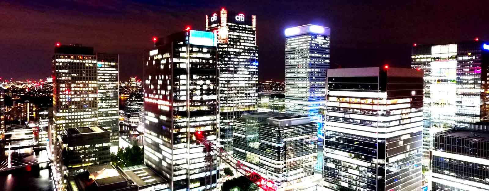Photo of buildings in the London city docklands at night.